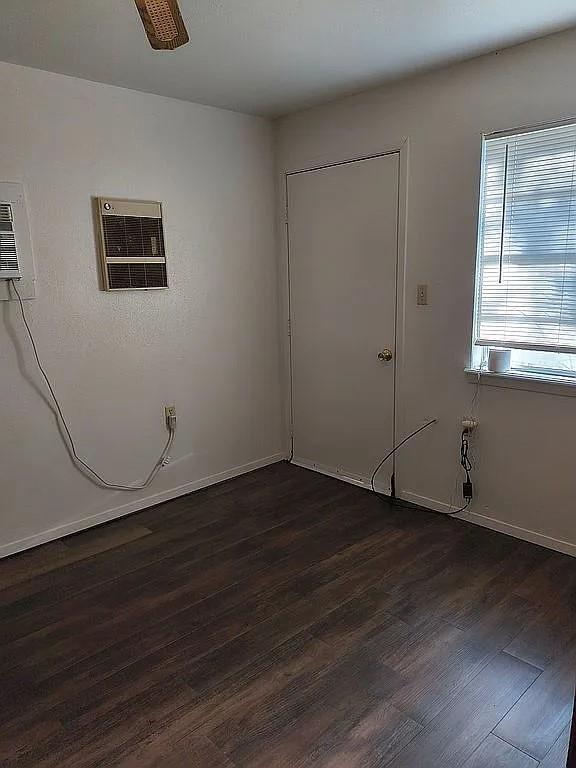 1250 Winn Road Bowie, TX 76230 - Photo 27 of 40 a view of an empty room with wooden floor and a window