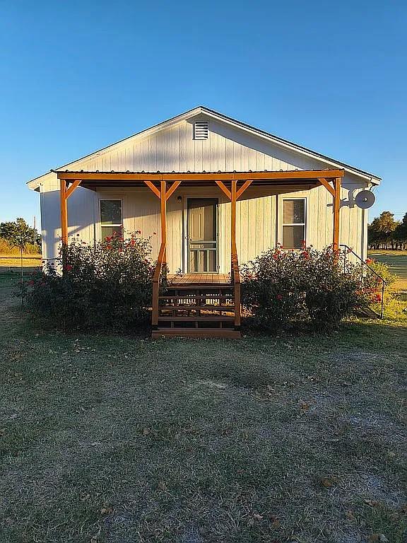 1250 Winn Road Bowie, TX 76230 - Photo 3 of 40 a front view of a house with garden