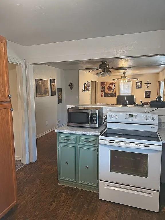 1250 Winn Road Bowie, TX 76230 - Photo 31 of 40 a kitchen with a stove and cabinets