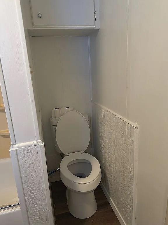 1250 Winn Road Bowie, TX 76230 - Photo 39 of 40 a white toilet sitting in a bathroom next to a sink