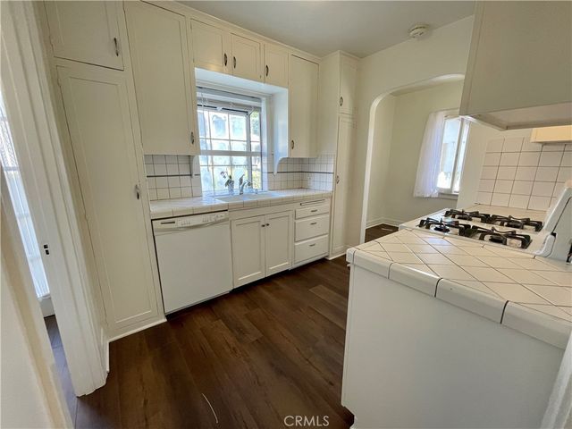 a kitchen with sink and cabinets