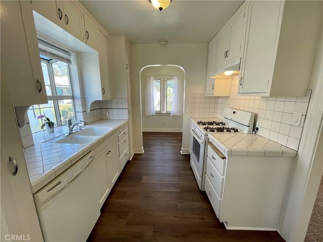 a kitchen with granite countertop a stove and a sink