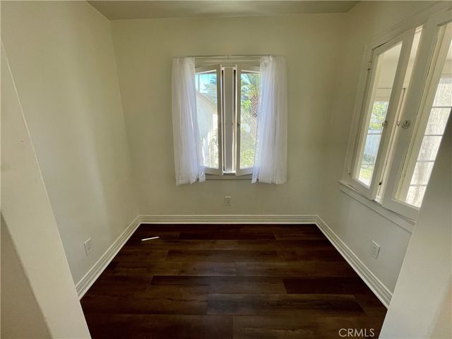 a view of a room with wooden floor and window