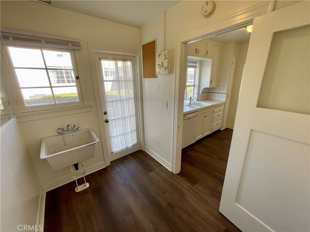 a room with a wooden floor and a bathroom
