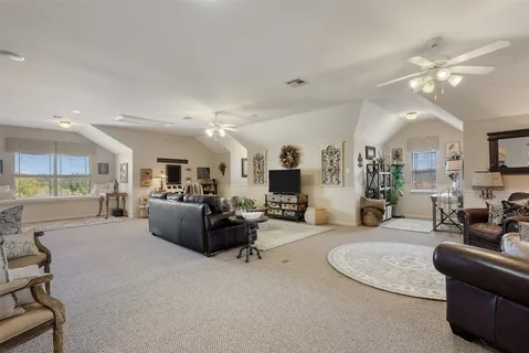 a living room with furniture and kitchen view
