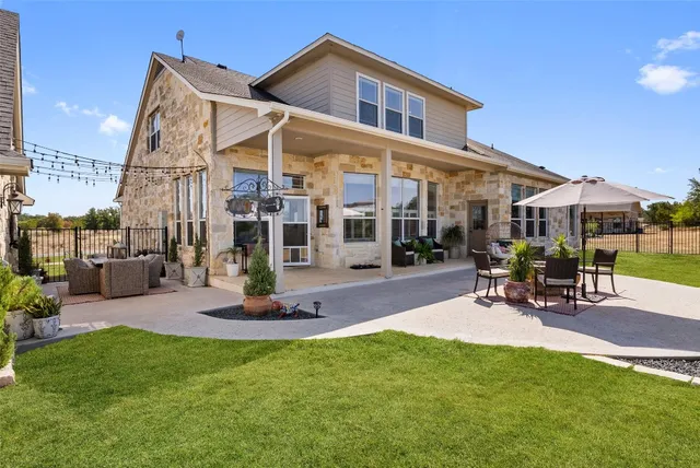 a view of a house with backyard porch and sitting area