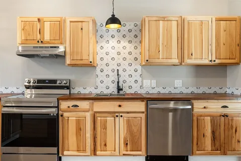 a kitchen with stainless steel appliances granite countertop a stove a sink and dishwasher