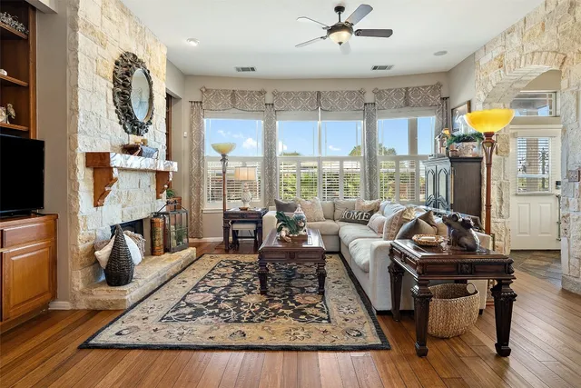 a living room with furniture and a floor to ceiling window