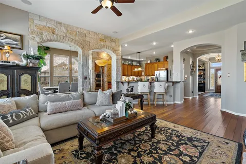 a living room with furniture and wooden floor