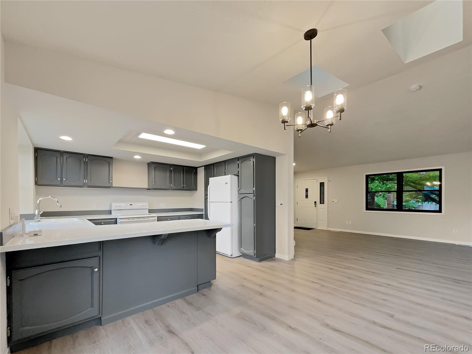 14 Maple Drive Frederick, CO 80530 - Photo 11 of 20 a kitchen with kitchen island a sink stainless steel appliances and cabinets