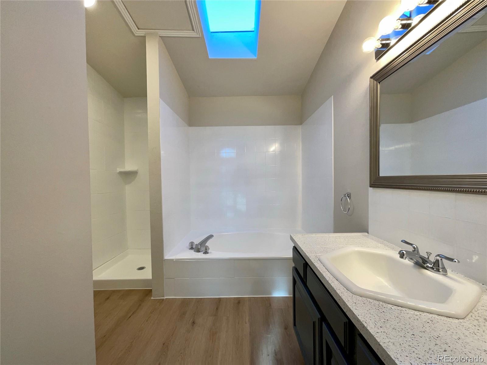 14 Maple Drive Frederick, CO 80530 - Photo 15 of 20 a bathroom with a bathtub and a sink