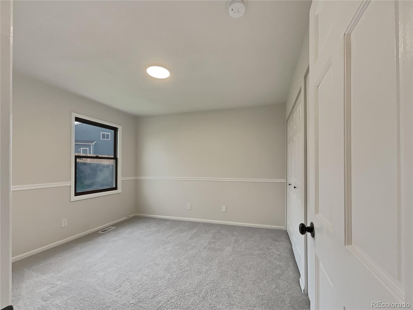 14 Maple Drive Frederick, CO 80530 - Photo 18 of 20 a view of an empty room with a window