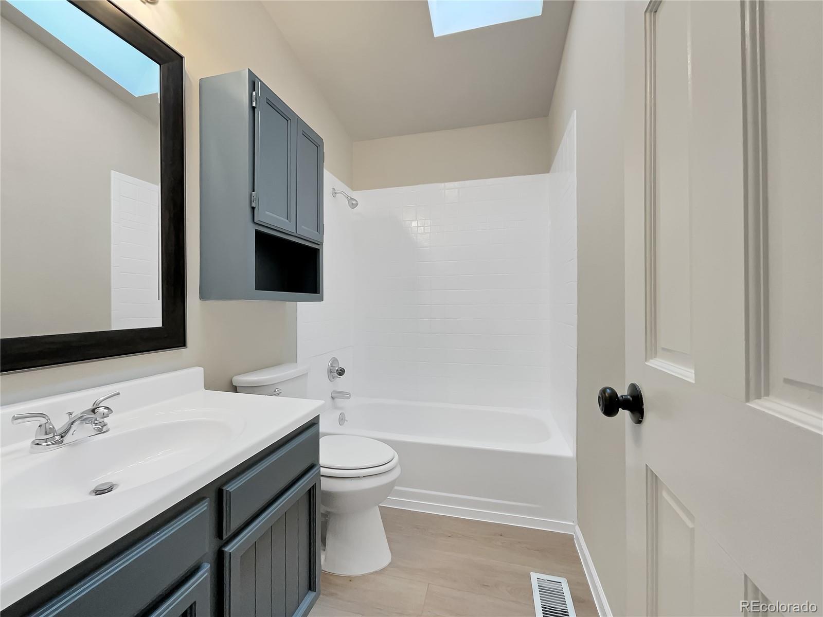 14 Maple Drive Frederick, CO 80530 - Photo 19 of 20 a bathroom with a sink a toilet and shower