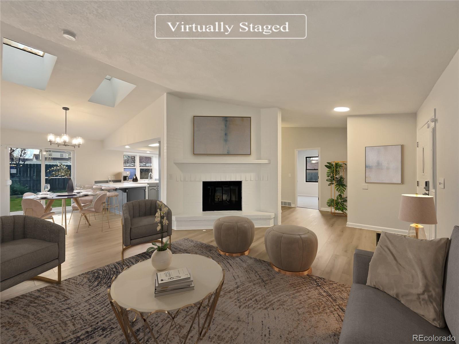 14 Maple Drive Frederick, CO 80530 - Photo 2 of 20 a living room with furniture kitchen view and a fireplace