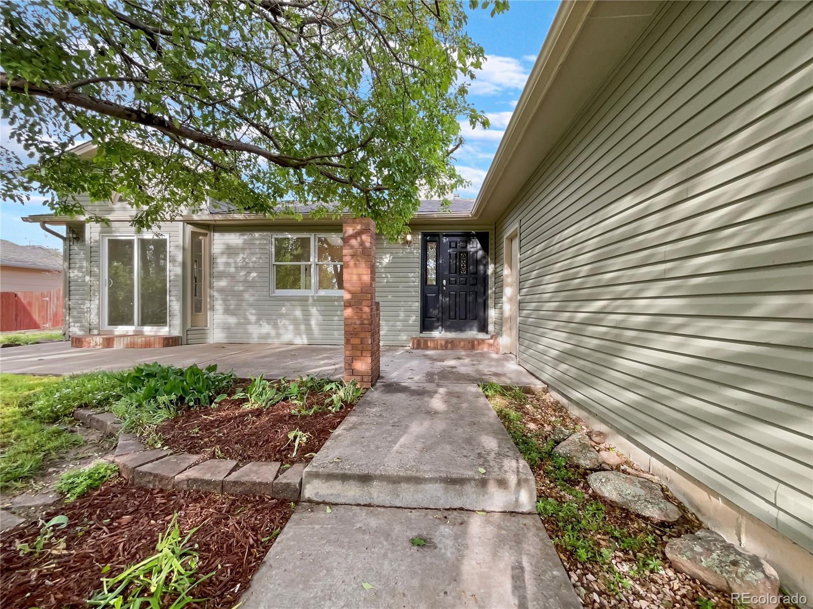 14 Maple Drive Frederick, CO 80530 - Photo 6 of 20 a front view of a house with garden
