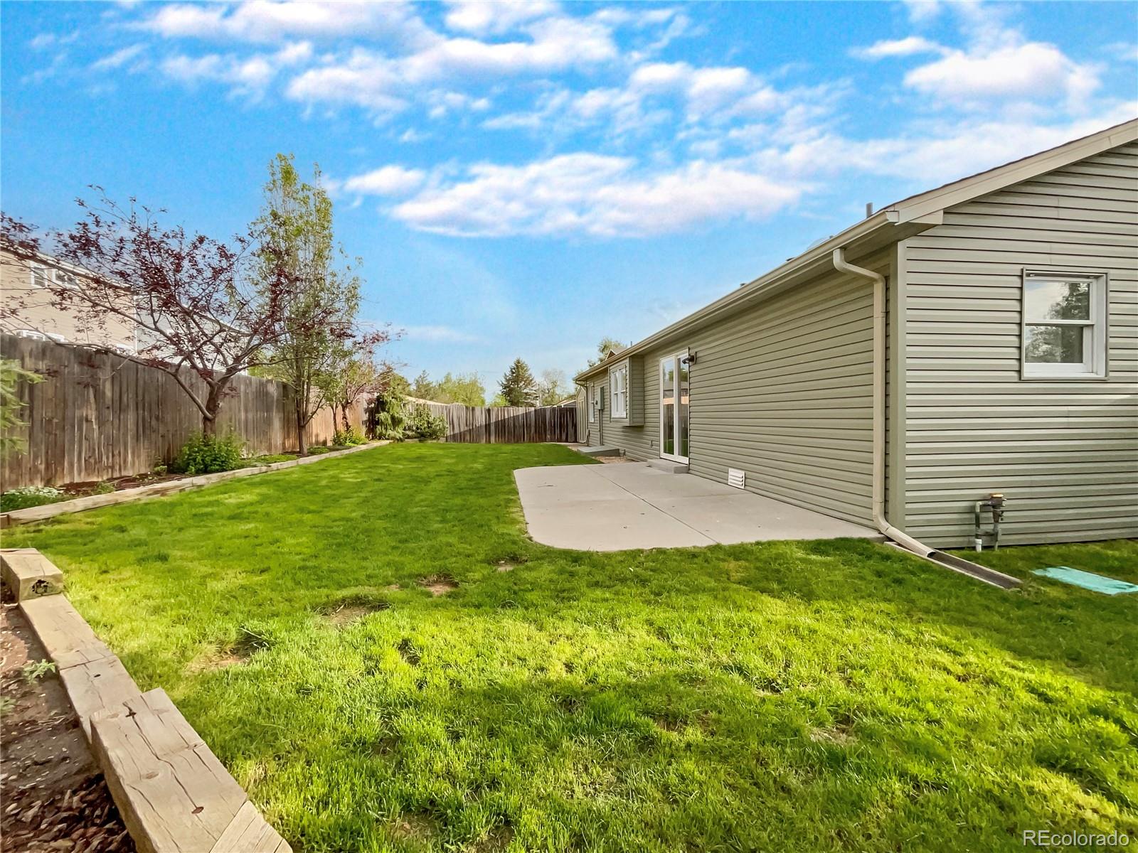 14 Maple Drive Frederick, CO 80530 - Photo 8 of 20 a view of a backyard with plants and a garden