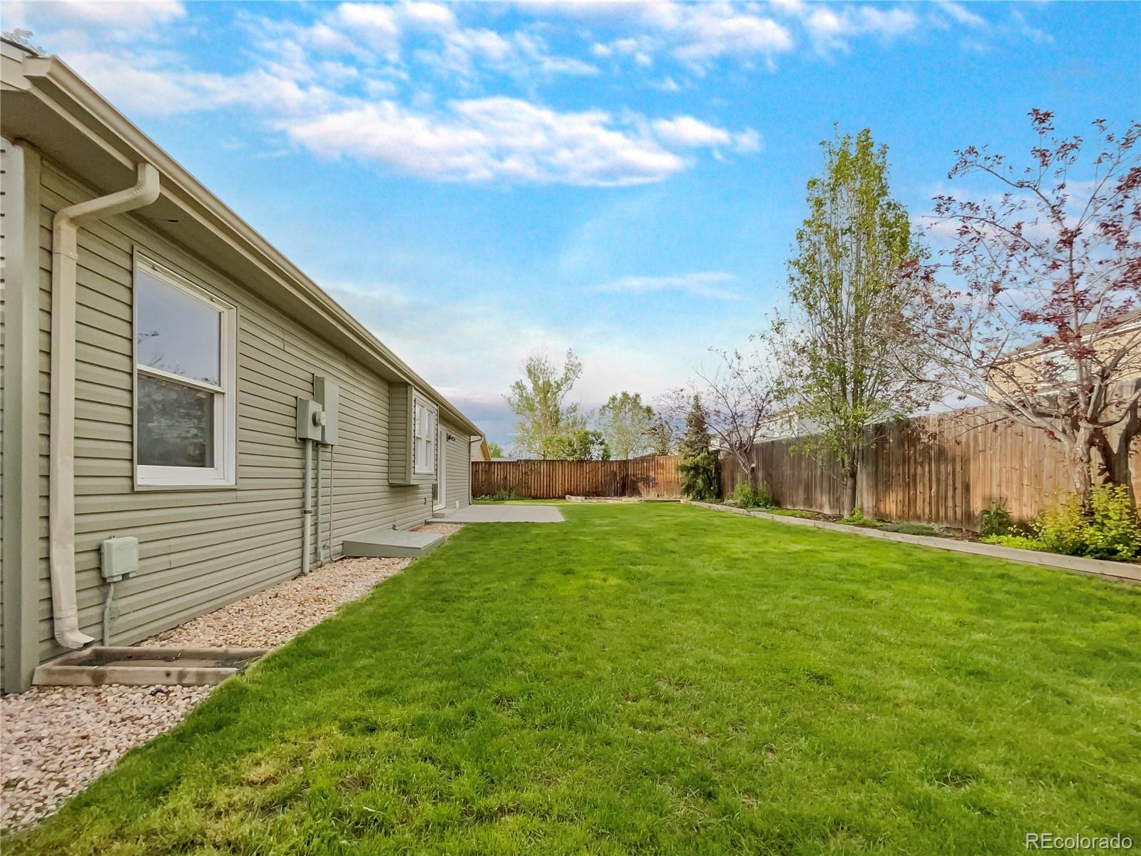 14 Maple Drive Frederick, CO 80530 - Photo 9 of 20 a backyard of a house with lots of green space