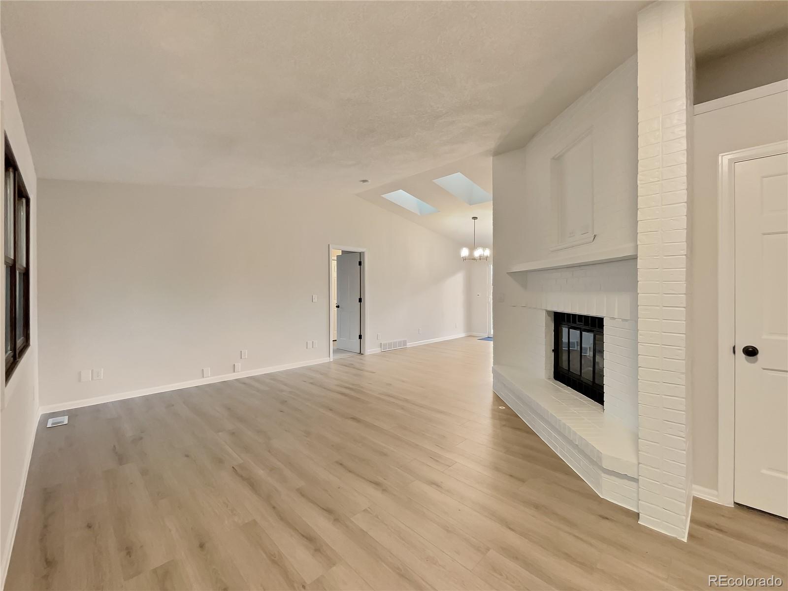 14 Maple Drive Frederick, CO 80530 - Photo 10 of 20 a view of a livingroom with wooden floor and a fireplace