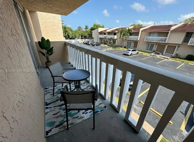 a view of a chairs and table in the balcony