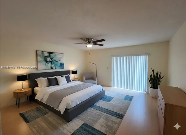 a bedroom with bed and a potted plant