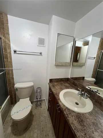 a bathroom with a sink toilet and mirror