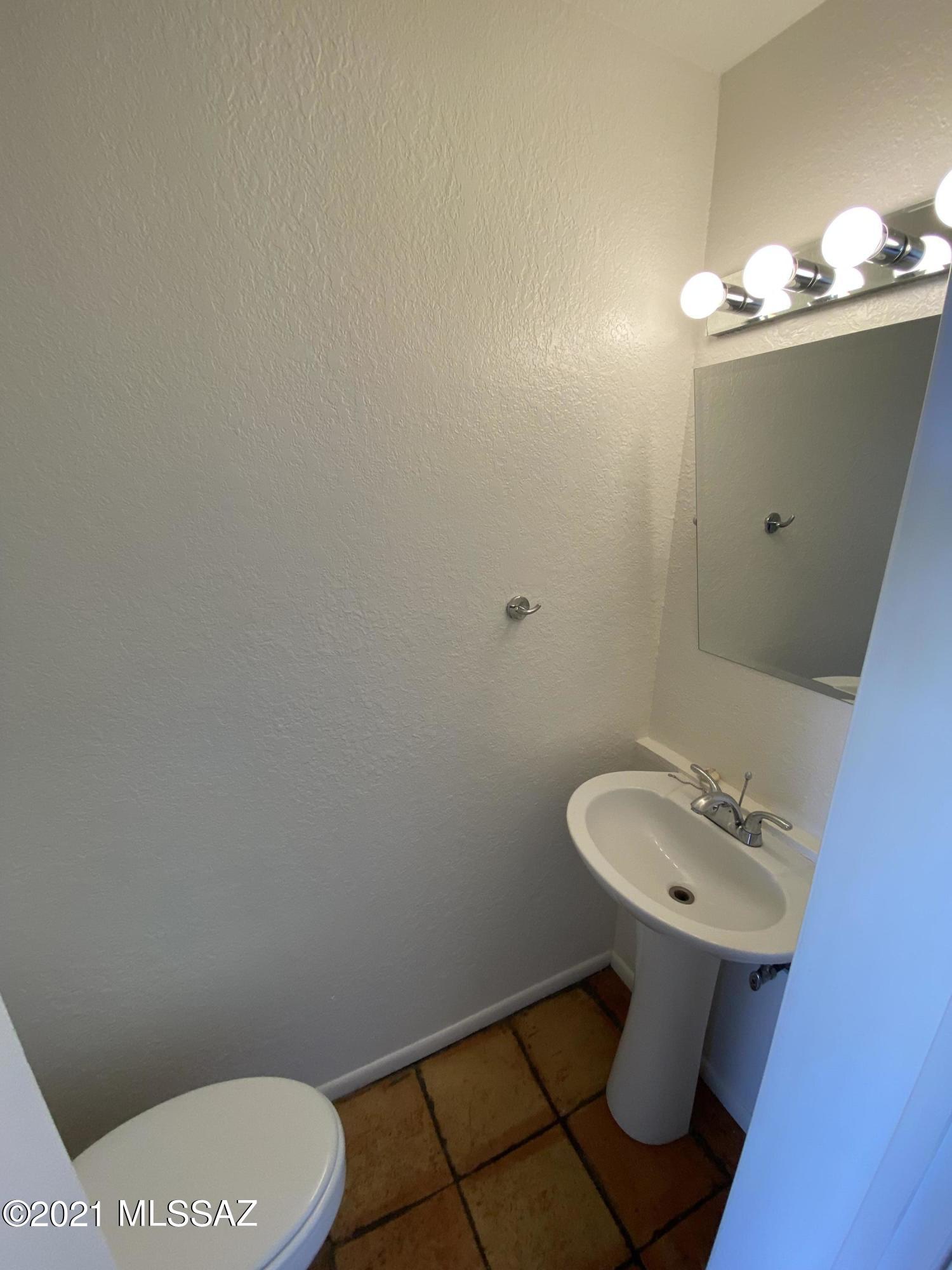 210 East Pastime Road Tucson, AZ 85705 - Photo 16 of 29 a bathroom with a sink toilet and mirror
