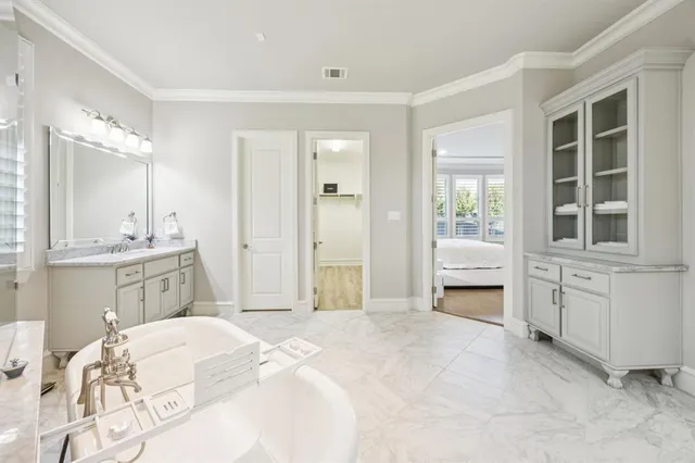 a spacious bedroom with a bed and a window