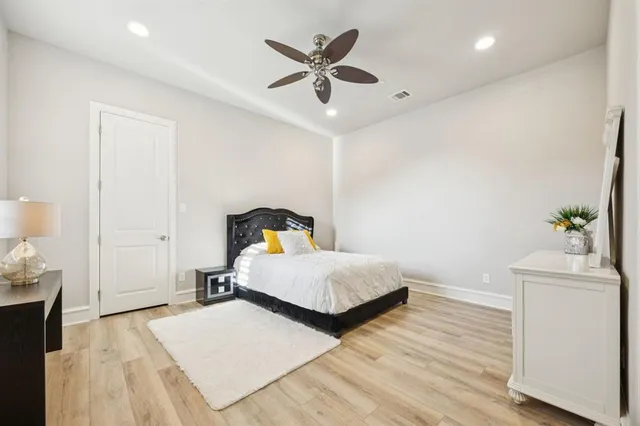 a bedroom with a bed and a potted plant