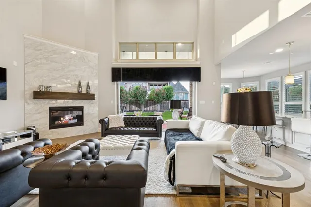 a living room with furniture a fireplace and a flat screen tv