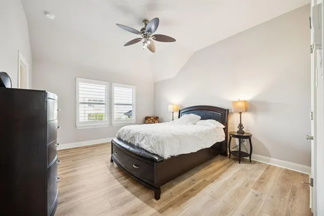 a spacious bedroom with a bed and a window