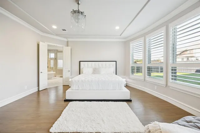 a bedroom with a large bed and a large window