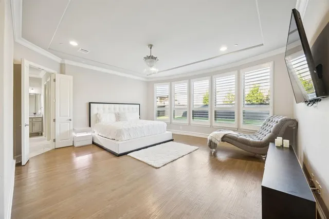 a spacious bedroom with a bed and a couch next to a window