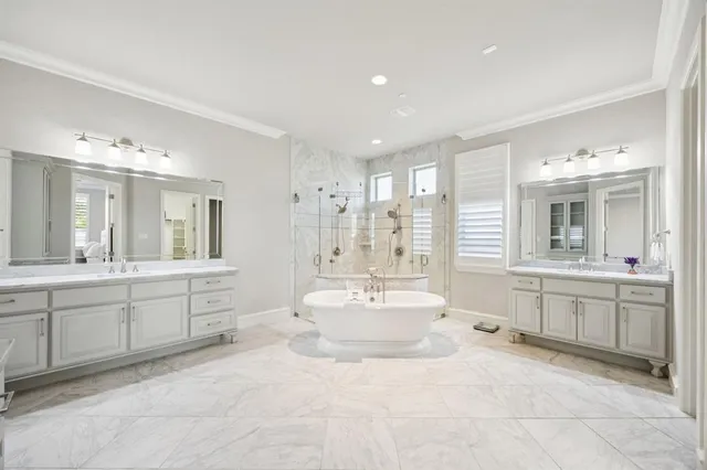 a large bathroom with a sink mirror and a bathtub