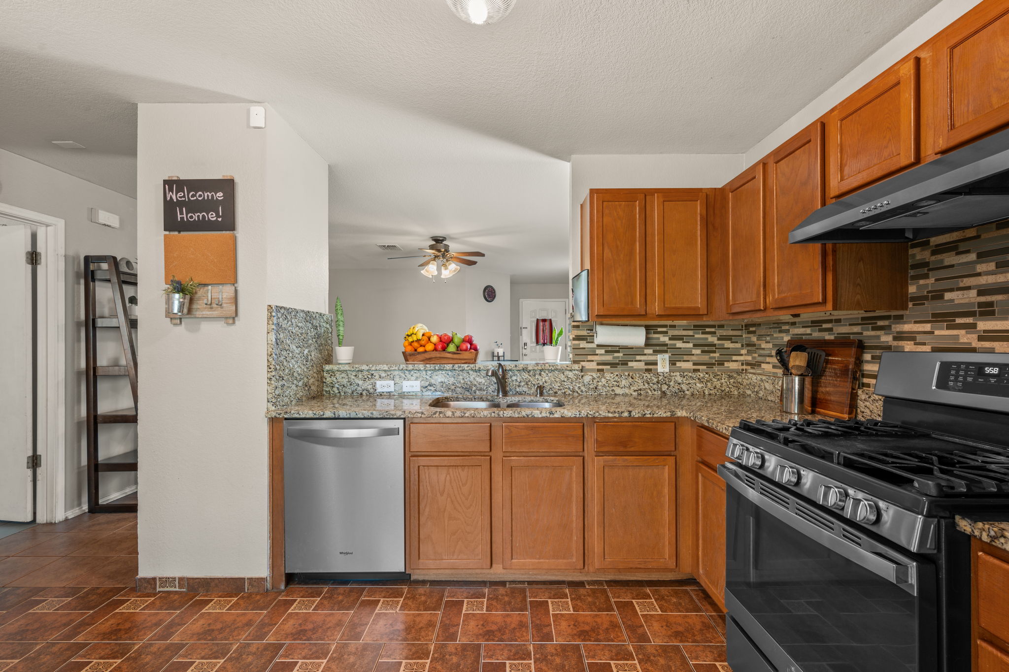 14206 Varrelman Street Austin, TX 78725 - Photo 11 of 27 a kitchen with stainless steel appliances granite countertop a stove a refrigerator and a sink