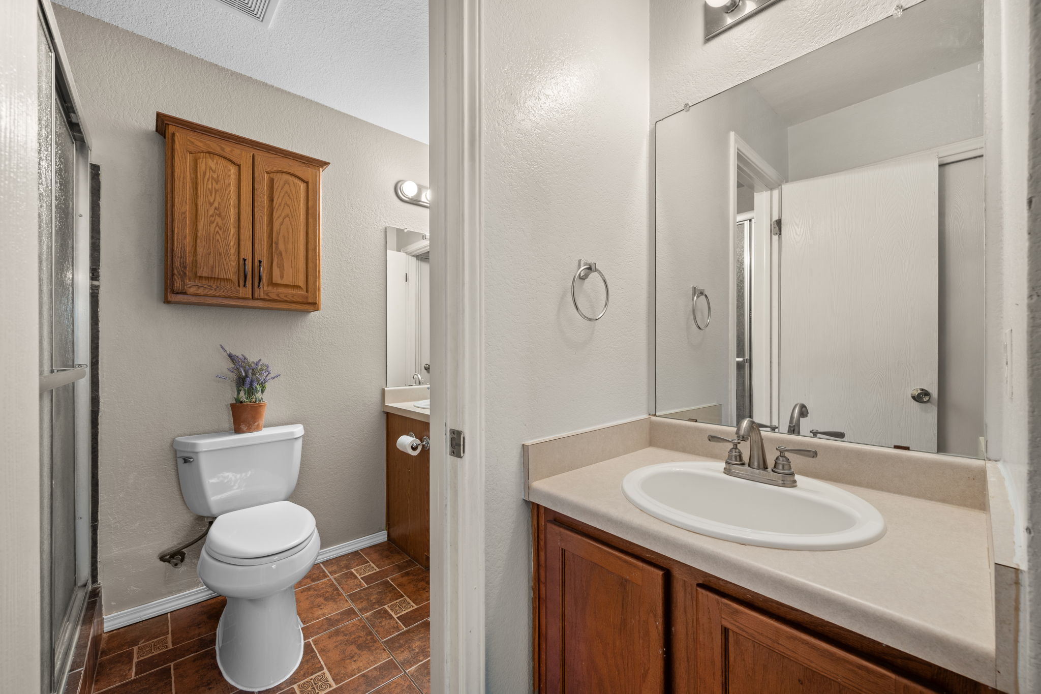 14206 Varrelman Street Austin, TX 78725 - Photo 15 of 27 a bathroom with a toilet sink and mirror