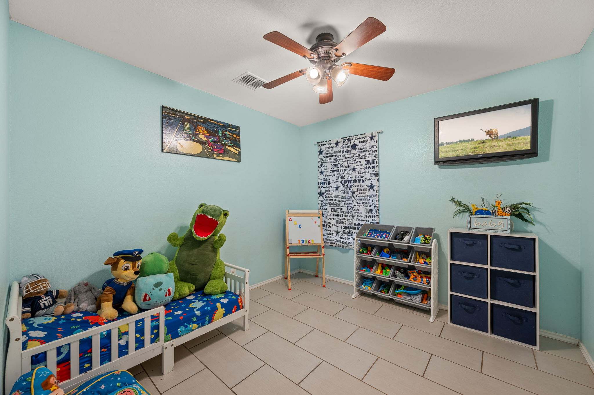 14206 Varrelman Street Austin, TX 78725 - Photo 19 of 27 a room with furniture a baby crib and a wooden floor