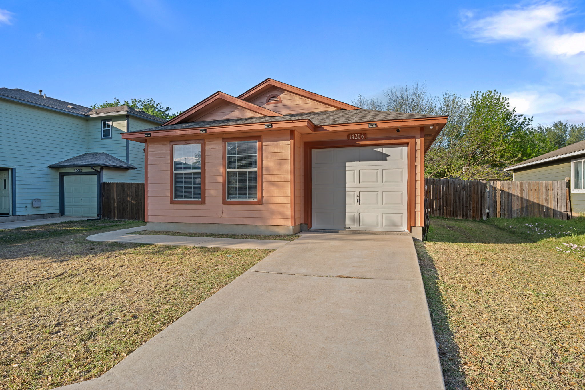 14206 Varrelman Street Austin, TX 78725 - Photo 2 of 27 a front view of a house with a yard and garage
