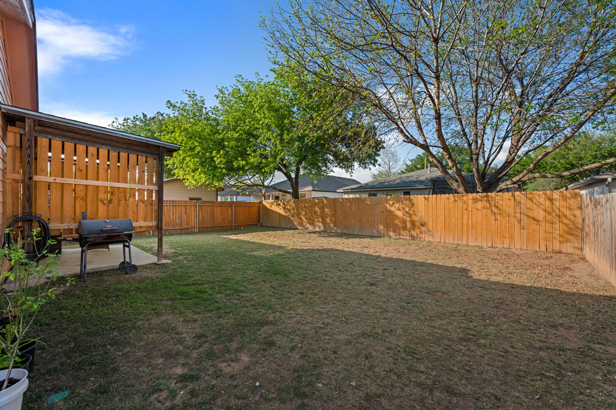14206 Varrelman Street Austin, TX 78725 - Photo 26 of 27 a backyard of a house with table and chairs