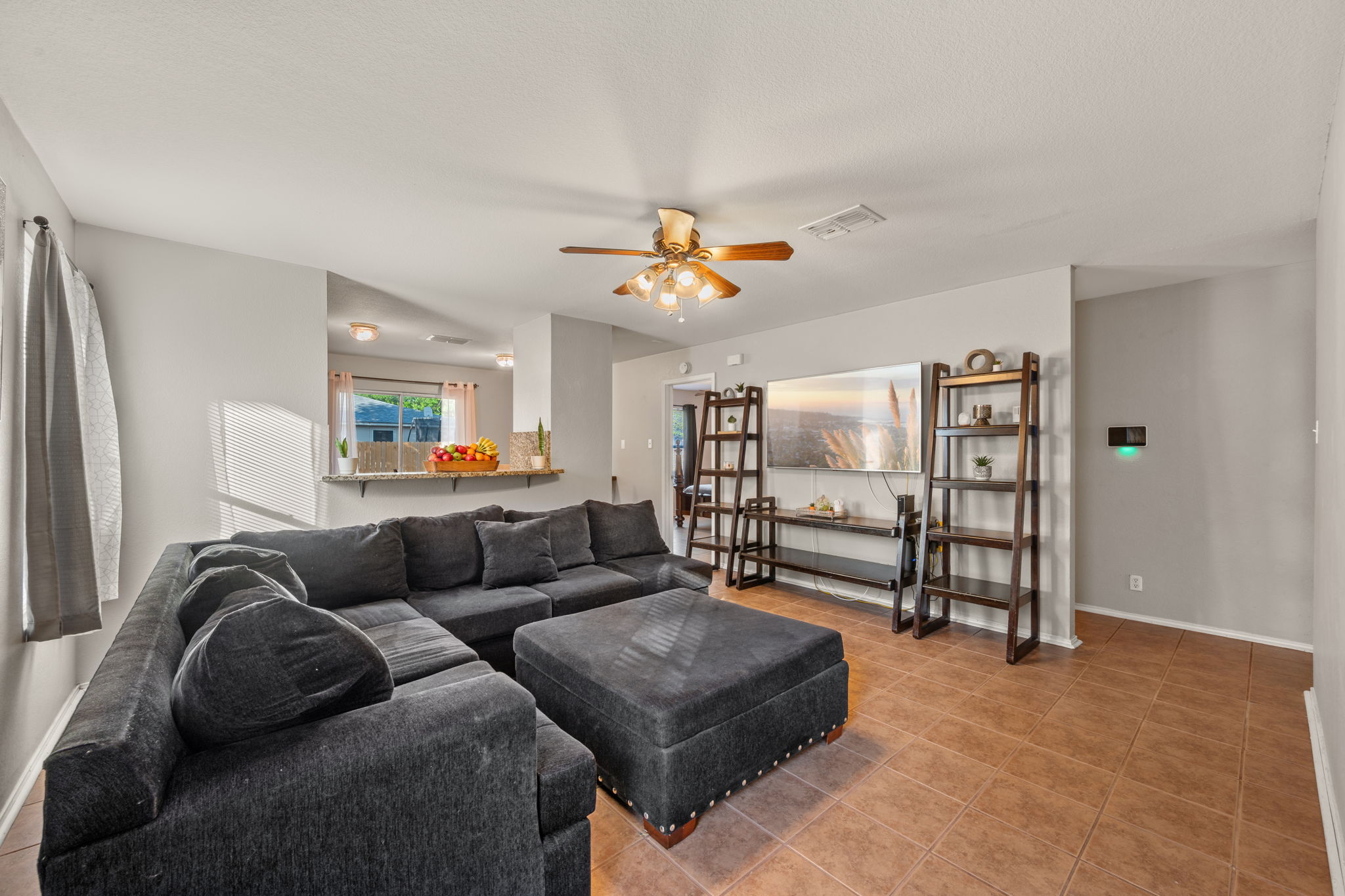 14206 Varrelman Street Austin, TX 78725 - Photo 4 of 27 a living room with furniture and a chandelier