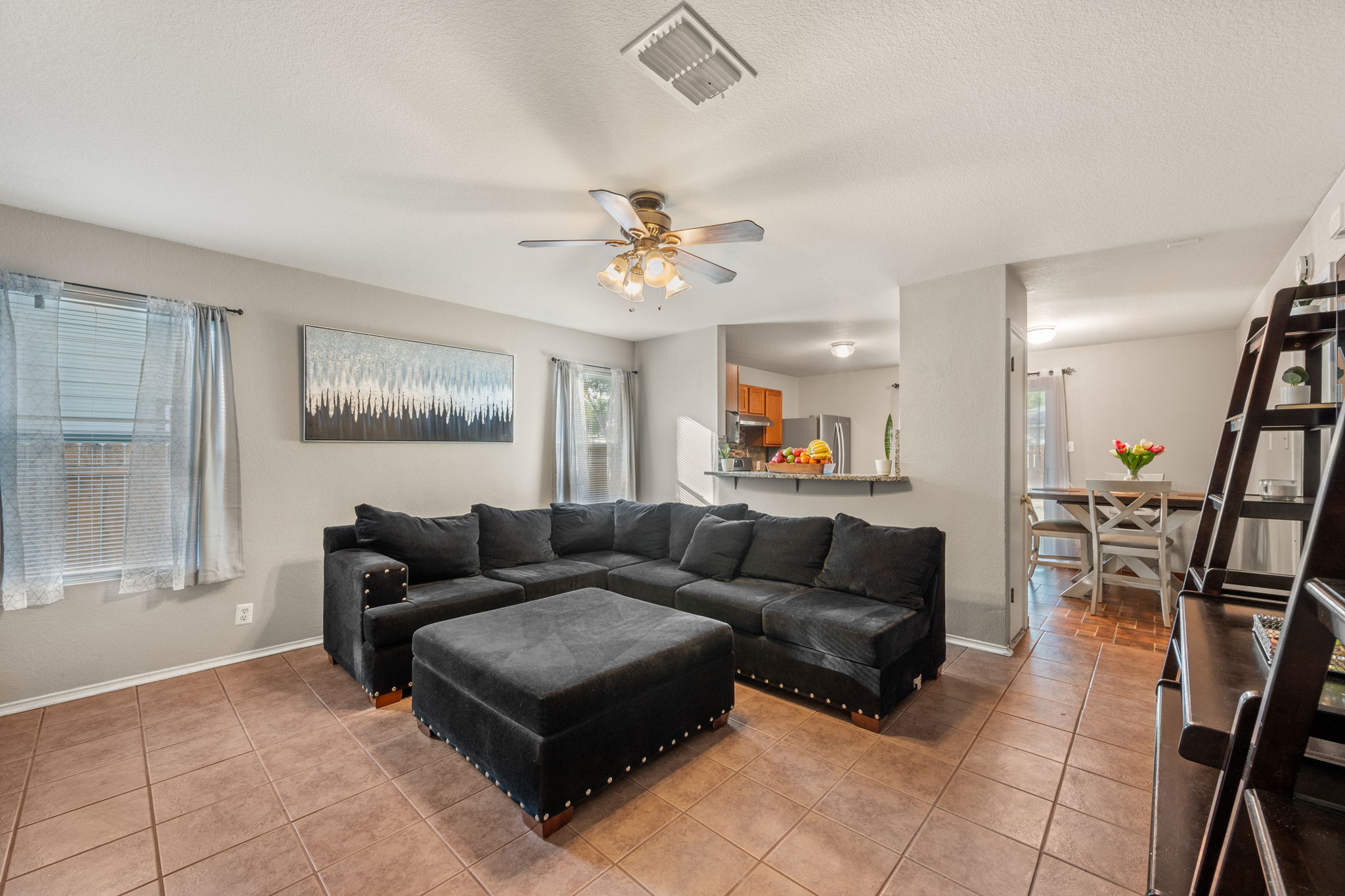 14206 Varrelman Street Austin, TX 78725 - Photo 5 of 27 a living room with furniture and a chandelier