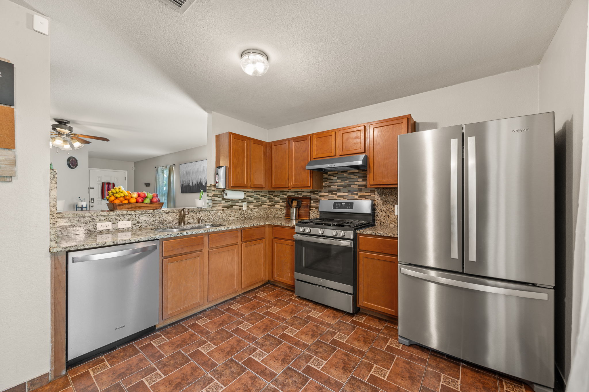 14206 Varrelman Street Austin, TX 78725 - Photo 9 of 27 a kitchen with stainless steel appliances granite countertop a refrigerator sink and stove