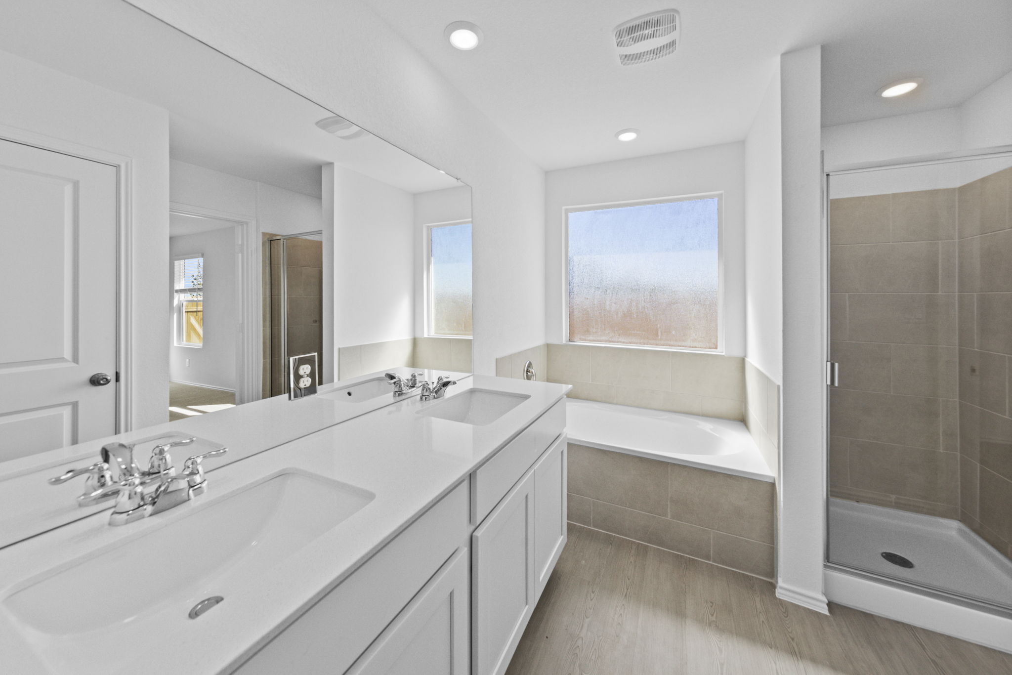 945 Soapstone Pass Maxwell, TX 78656 - Photo 18 of 19 a bathroom with a double vanity sink mirror double and bathtub