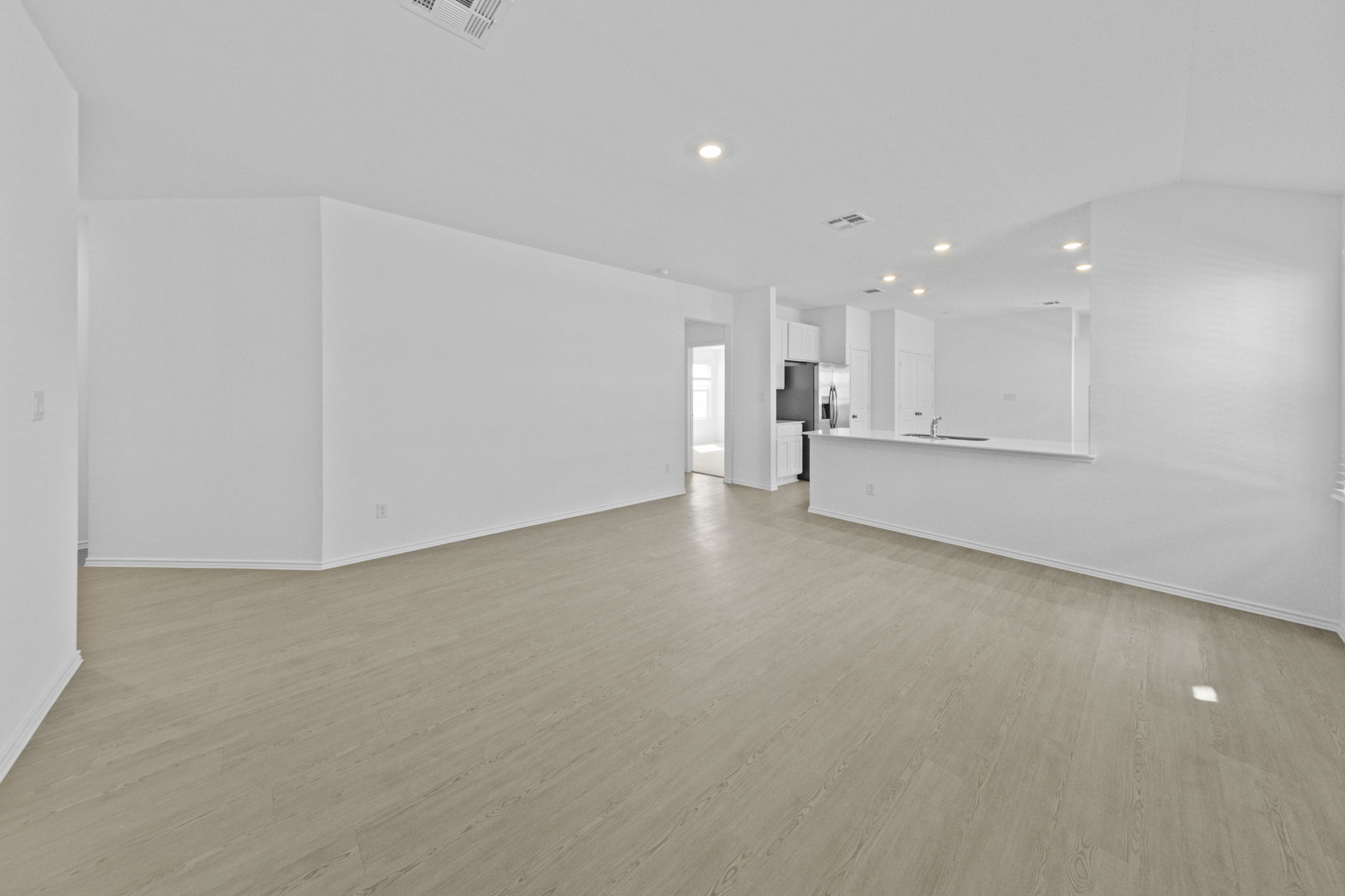 945 Soapstone Pass Maxwell, TX 78656 - Photo 6 of 19 a view of an empty room with a kitchen