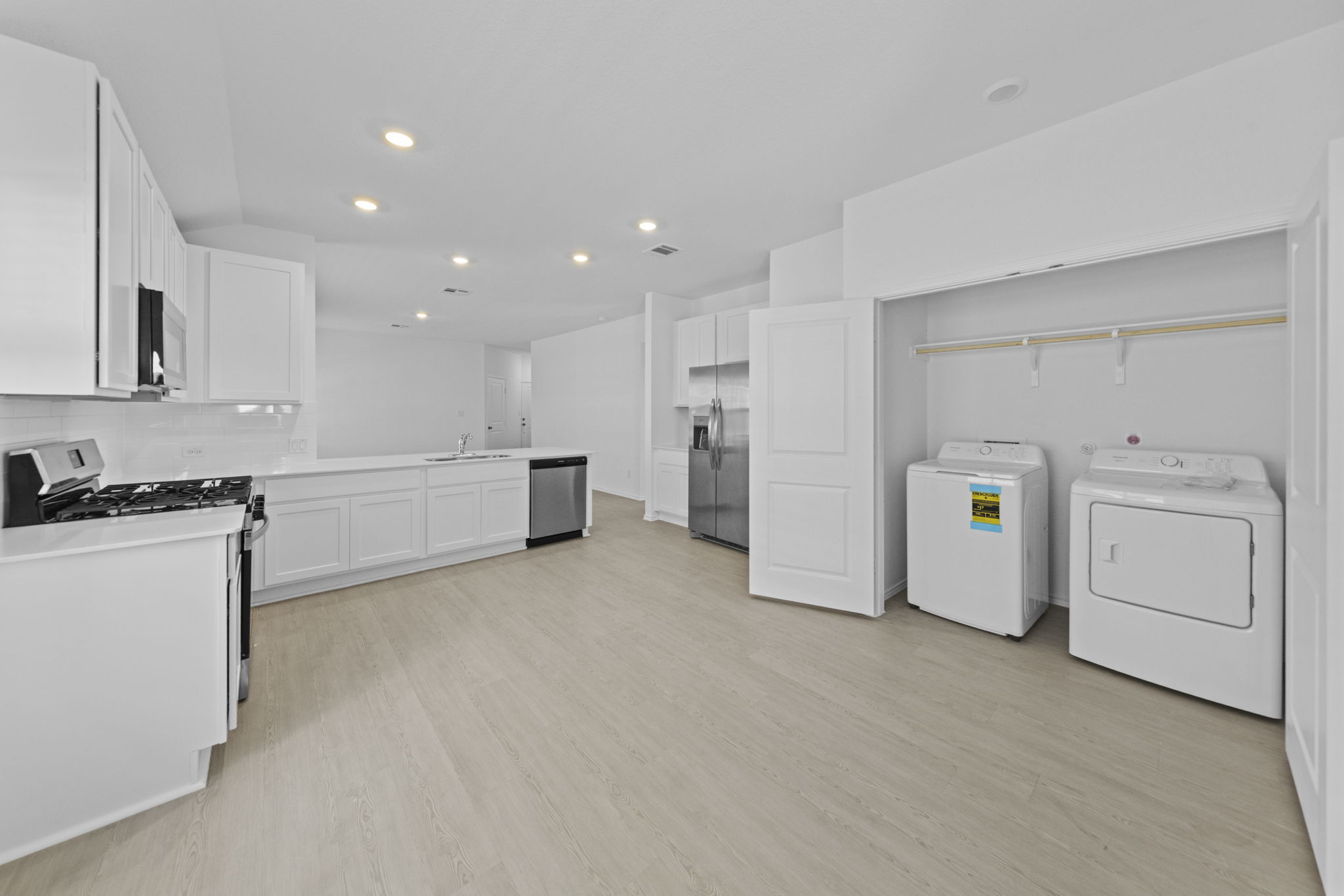 945 Soapstone Pass Maxwell, TX 78656 - Photo 10 of 19 a view of a kitchen with refrigerator and white cabinets