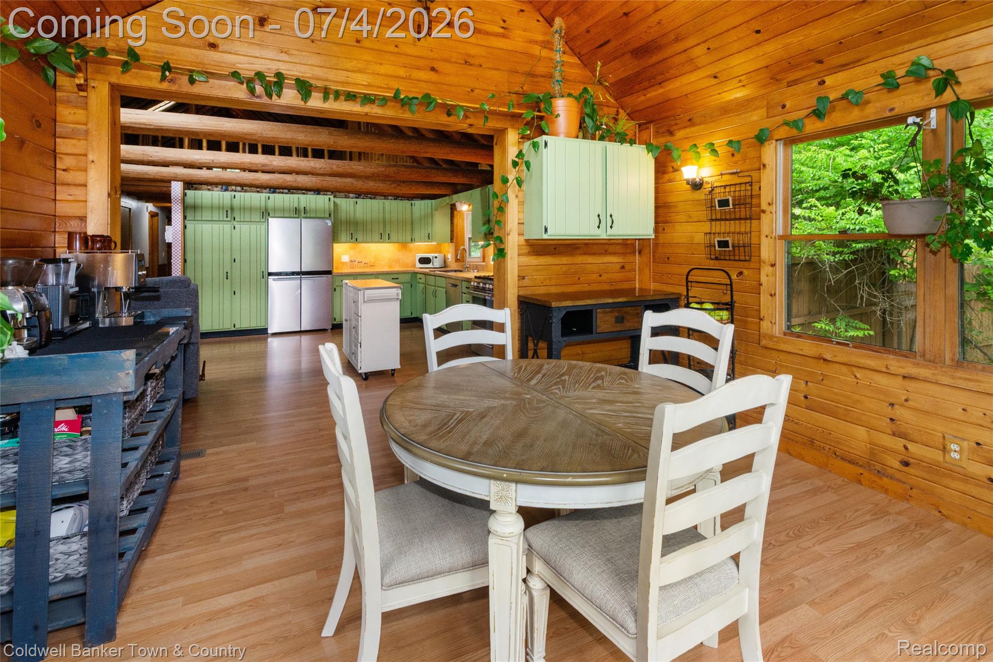 7335 Richardson Road Howell, MI 48843 - Photo 20 of 54 Wood-paneled room featuring a vaulted wood-beam ceiling, wood-finish flooring, and a large window