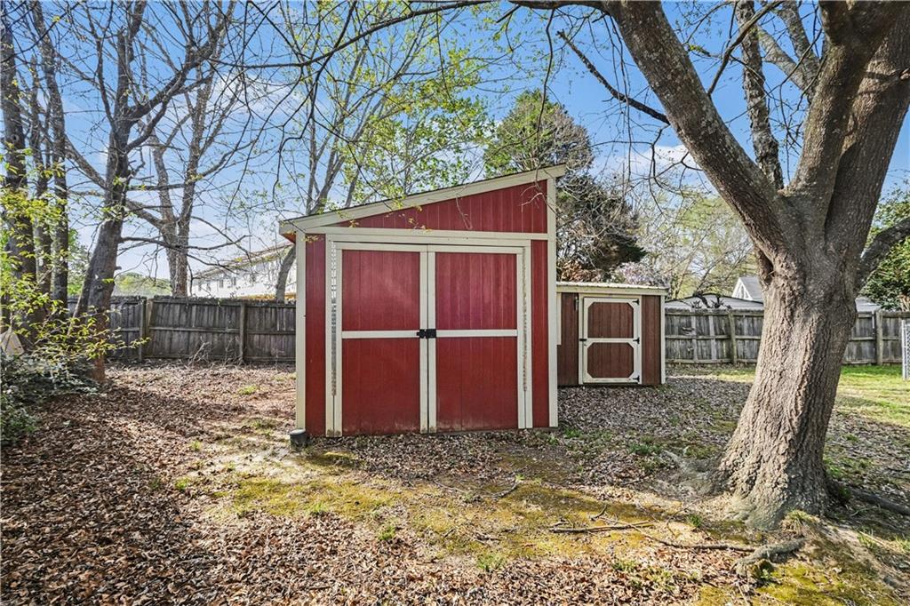 280 Courtyard Circle Winder, GA 30680 - Photo 23 of 24 a view of a barn in the backyard with large tree