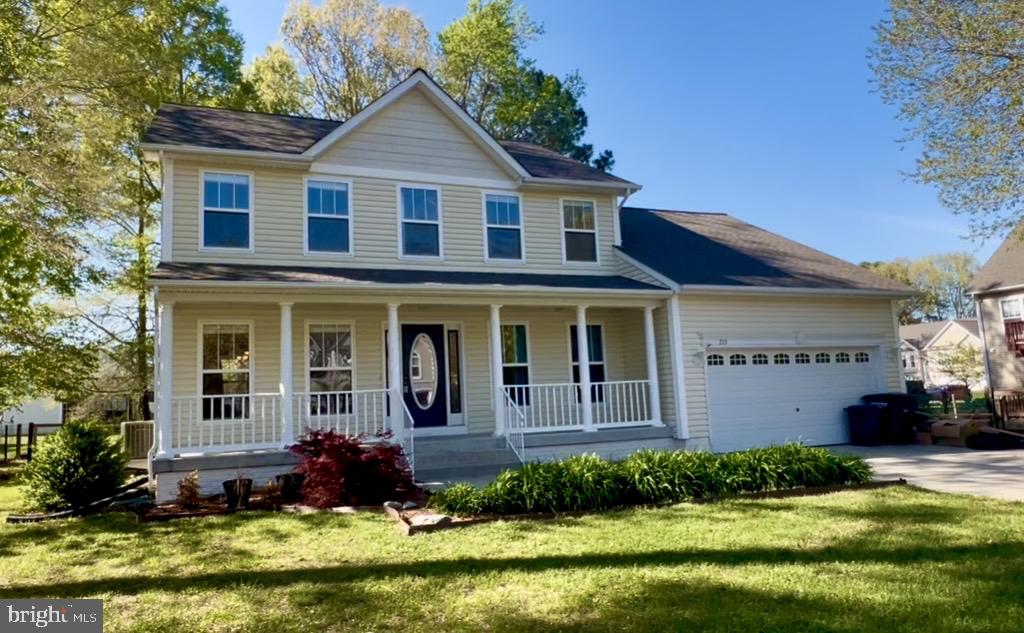 213 Forest Avenue Colonial Beach, VA 22443 - Photo 1 of 54 a front view of a house with a yard and garage