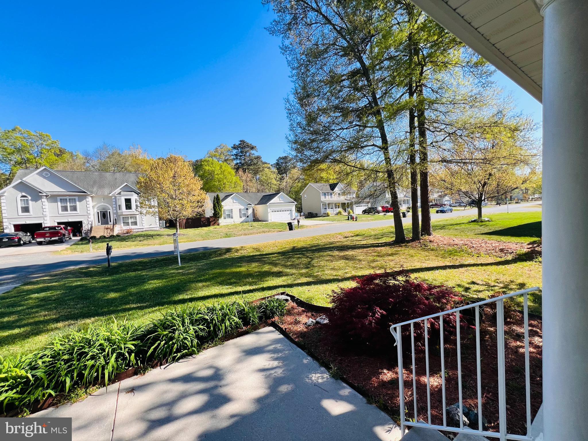 213 Forest Avenue Colonial Beach, VA 22443 - Photo 11 of 54 a view of a yard with flower plants and wooden fence
