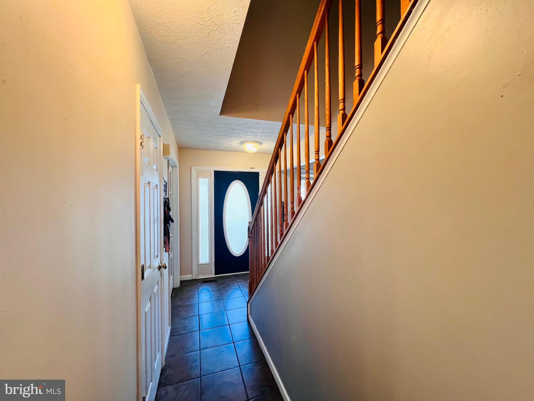 213 Forest Avenue Colonial Beach, VA 22443 - Photo 20 of 54 a view of a hallway with wooden floor and staircase
