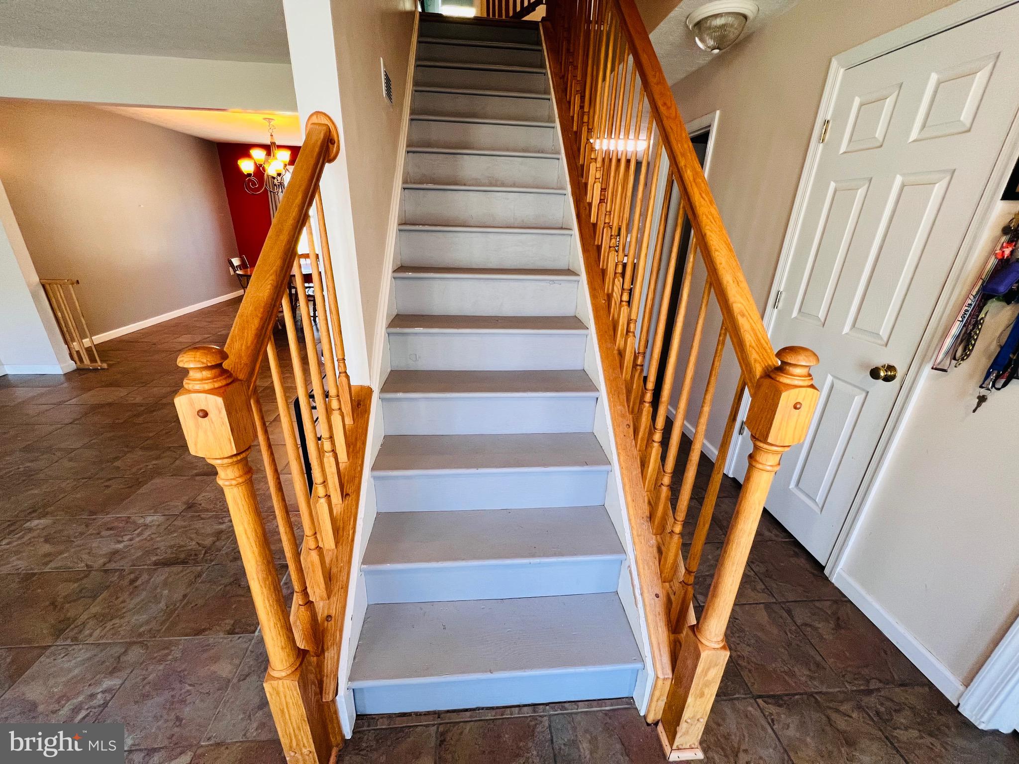 213 Forest Avenue Colonial Beach, VA 22443 - Photo 23 of 54 a view of staircase with wooden floor and a potted plant